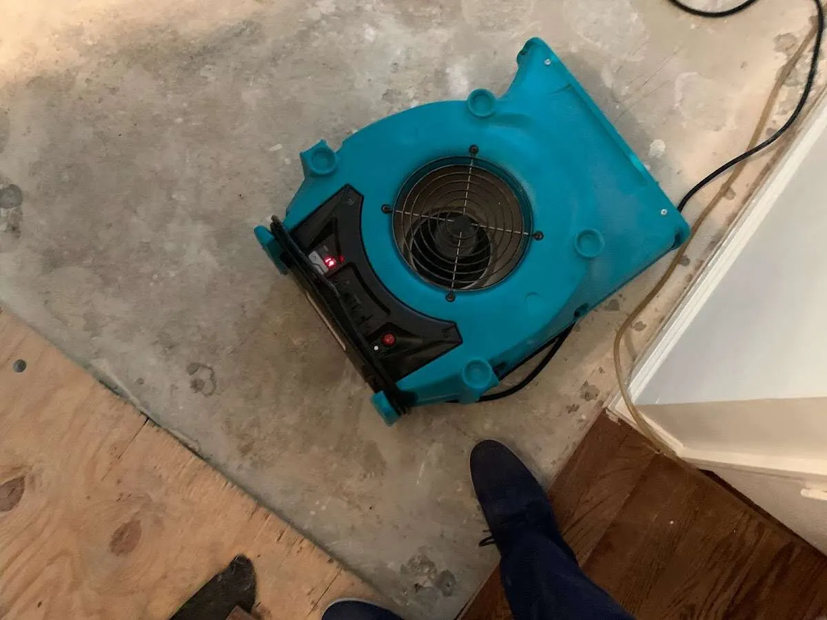 Air mover drying subfloor during Commercial Water Damage Restoration in Yankee Springs